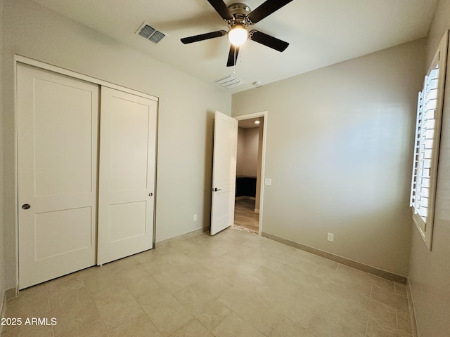 unfurnished bedroom with multiple windows, a closet, and ceiling fan