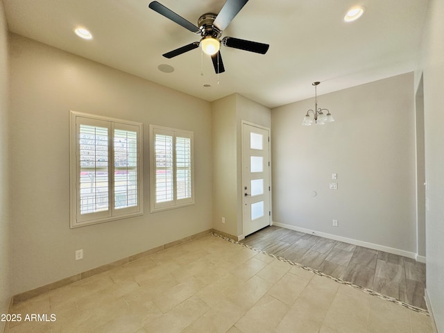 interior space with ceiling fan with notable chandelier