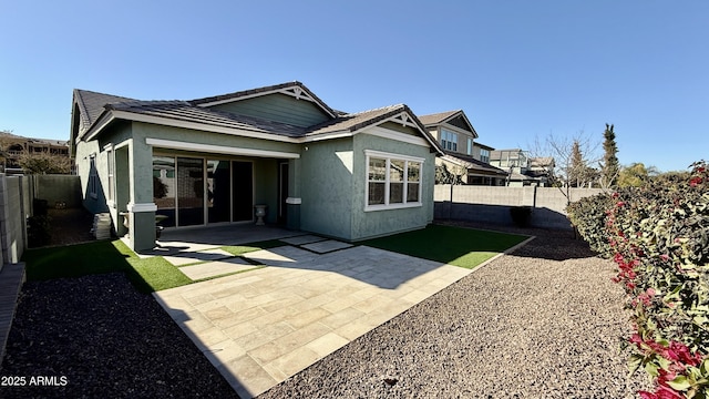 back of house with a patio