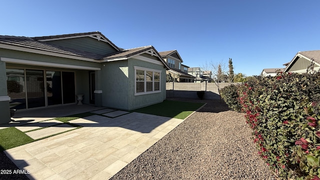 view of side of property with a patio area