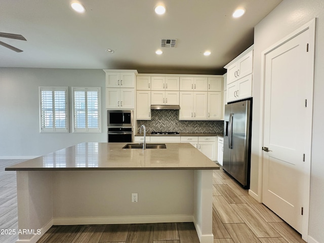 kitchen featuring tasteful backsplash, appliances with stainless steel finishes, sink, and white cabinets