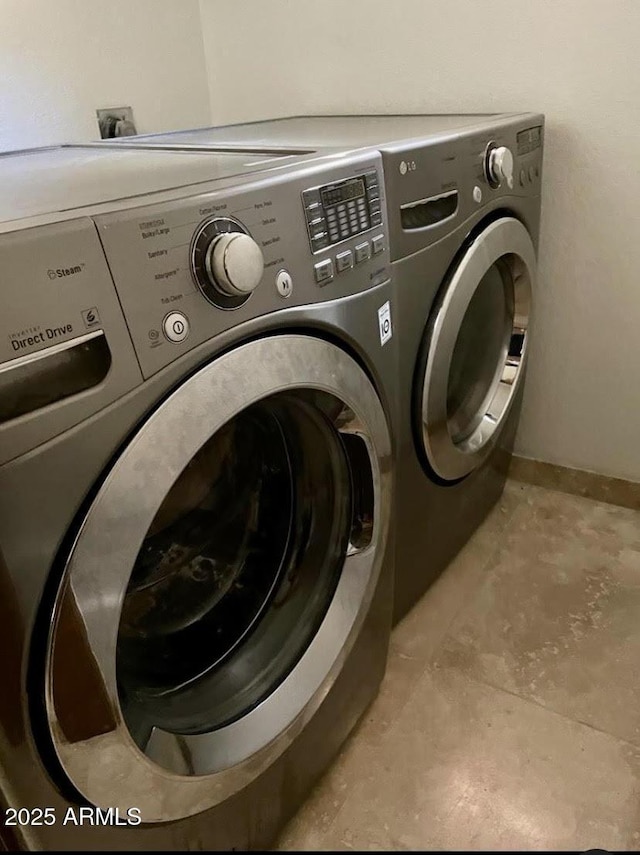 clothes washing area featuring washer and clothes dryer