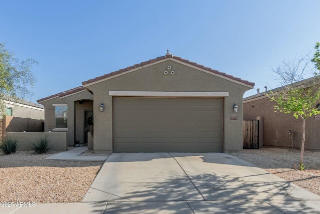 40467 W Jenna Ln, Maricopa, AZ 85138 - view of front of home with stucco siding, an attached garage, driveway, and fence