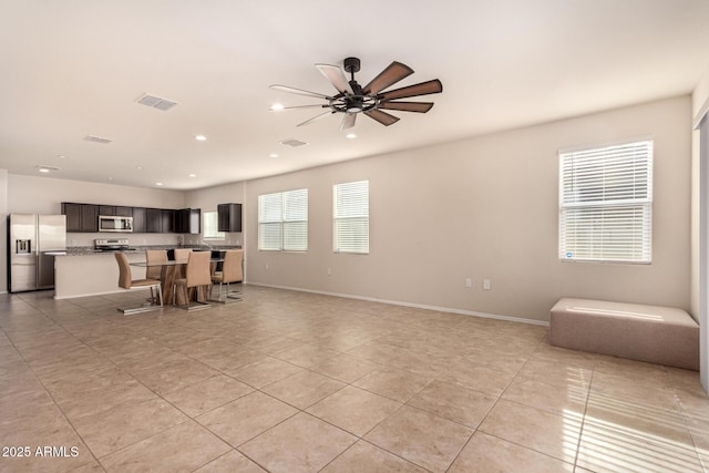 living room featuring ceiling fan and light tile patterned floors