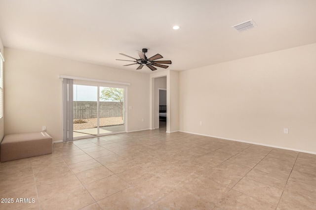 tiled spare room with ceiling fan