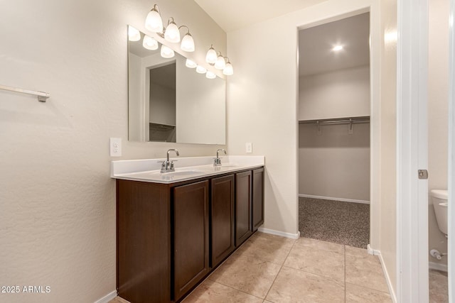 bathroom featuring tile patterned floors, vanity, and toilet