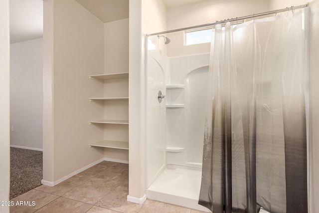 bathroom with a shower with shower curtain and tile patterned floors