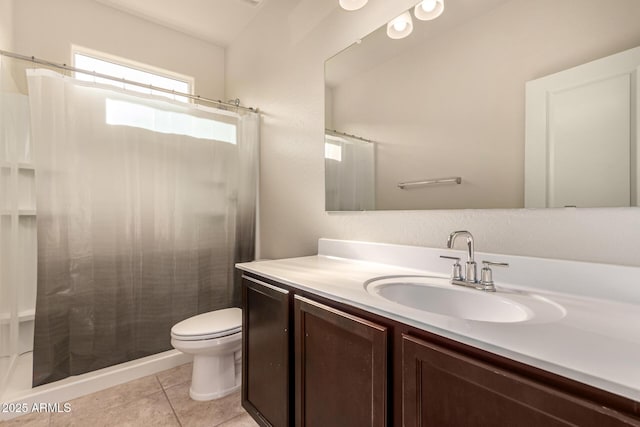 bathroom featuring tile patterned flooring, a shower with curtain, vanity, and toilet