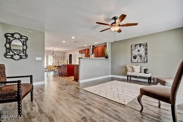 1045 S Solomon St, Mesa, AZ 85204 - sitting room with baseboards, a ceiling fan, wood finished floors, recessed lighting, and a textured ceiling