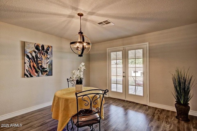 1045 S Solomon St, Mesa, AZ 85204 - dining space with french doors, dark wood-type flooring, a chandelier, a textured ceiling, and baseboards