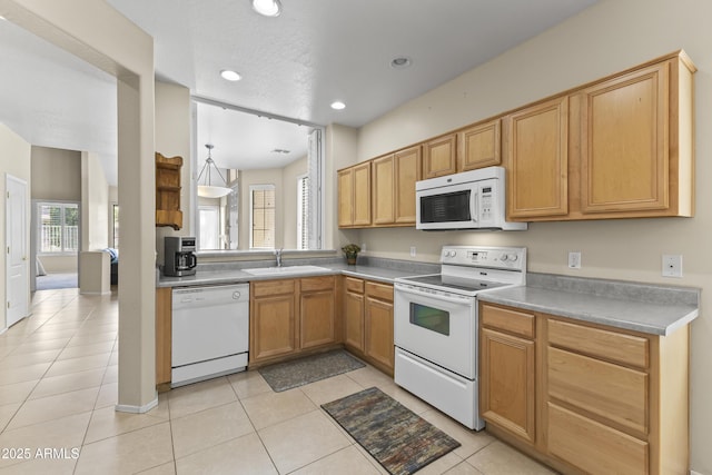 kitchen with white appliances, recessed lighting, a sink, light tile patterned floors, and decorative light fixtures
