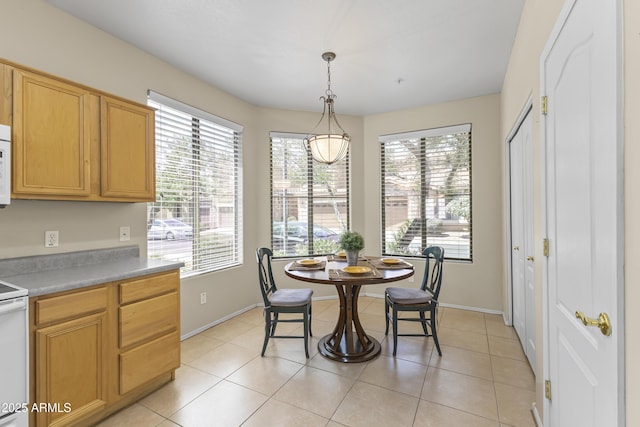dining area with baseboards and light tile patterned floors
