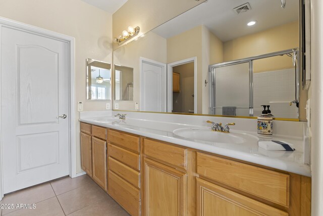 full bathroom with visible vents, a sink, tile patterned flooring, and a shower stall