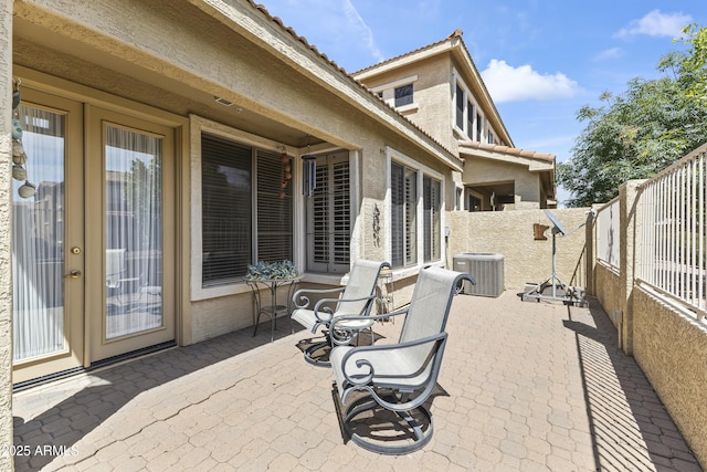 view of patio with a fenced backyard and central AC unit