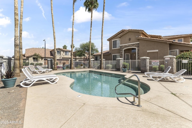 pool with fence and a patio