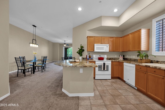 kitchen featuring pendant lighting, a sink, baseboards, light carpet, and white appliances