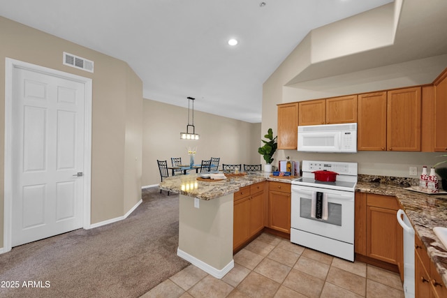 kitchen featuring visible vents, hanging light fixtures, light stone countertops, a peninsula, and white appliances
