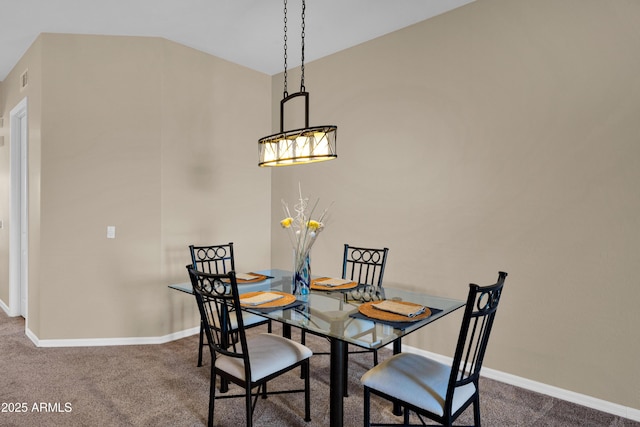 carpeted dining room with baseboards