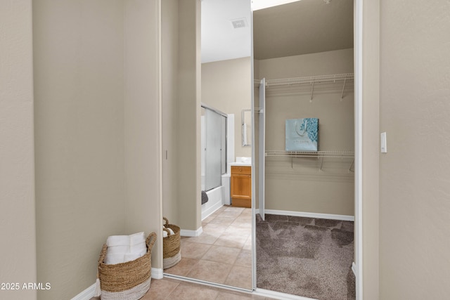 full bath featuring tile patterned flooring, baseboards, and shower / tub combination