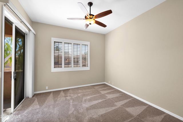 empty room featuring baseboards, a ceiling fan, and carpet flooring