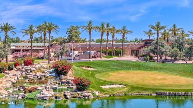 surrounding community featuring a lawn and view of golf course