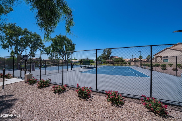 view of sport court featuring fence