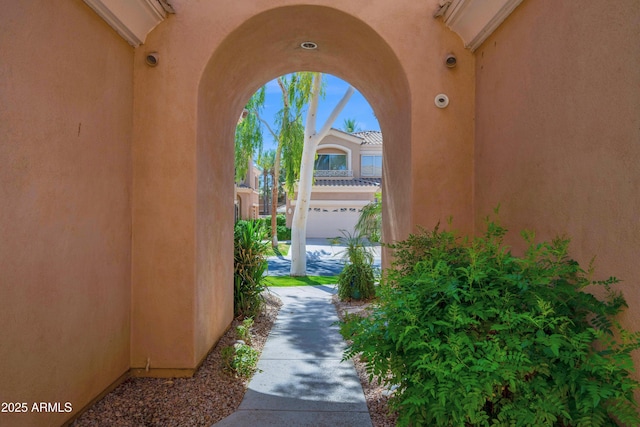 doorway to property featuring stucco siding