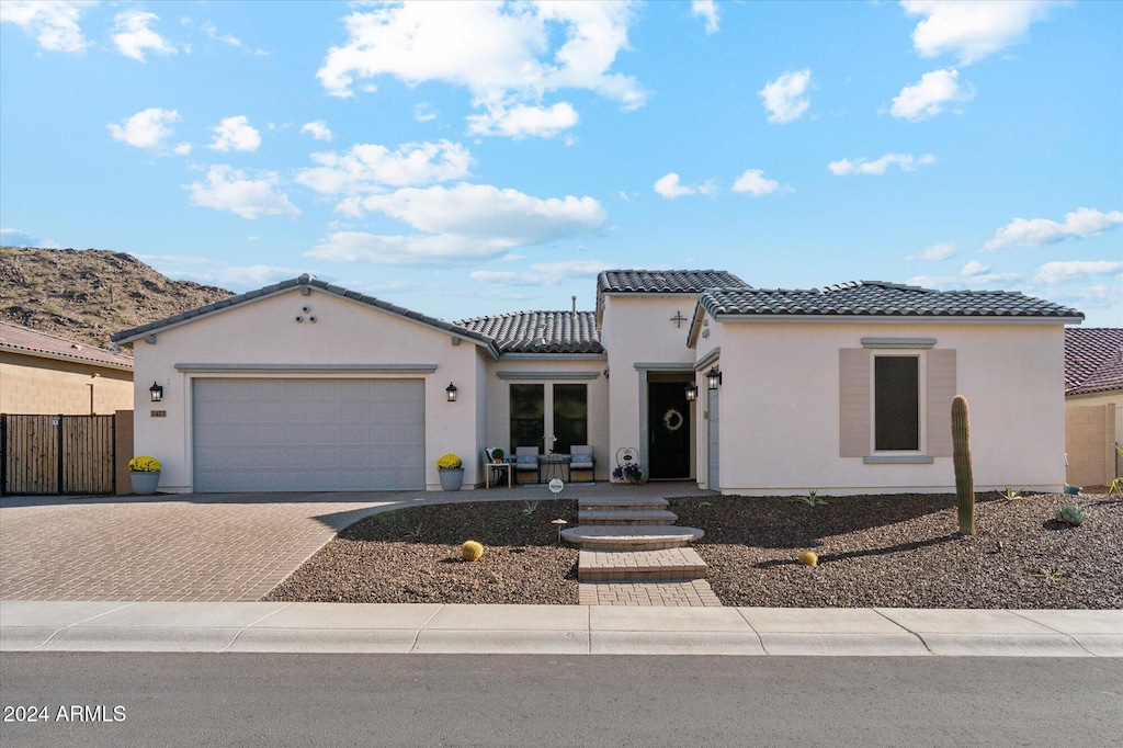 view of front of home featuring a mountain view and a garage