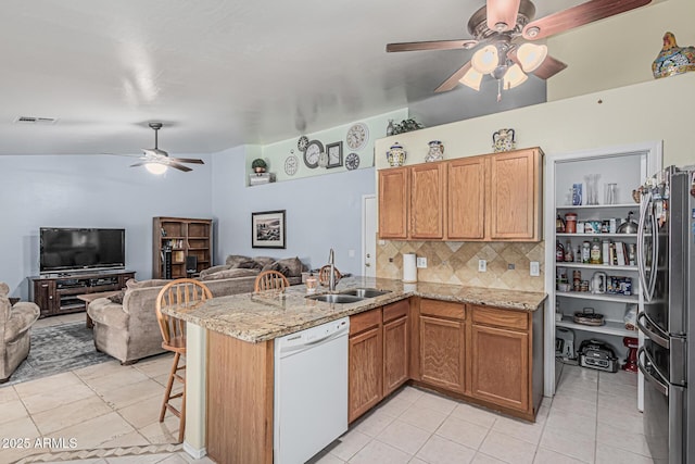 3059 E Tyson Ct, Gilbert, AZ 85295 - kitchen with white dishwasher, freestanding refrigerator, a sink, ceiling fan, and open floor plan