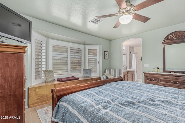 3059 E Tyson Ct, Gilbert, AZ 85295 - bedroom featuring wood finished floors, ceiling fan, arched walkways, and ensuite bath