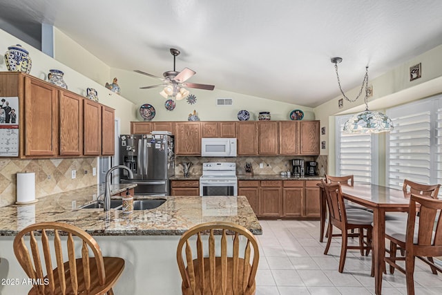 3059 E Tyson Ct, Gilbert, AZ 85295 - kitchen featuring white appliances, a sink, a peninsula, vaulted ceiling, and decorative backsplash