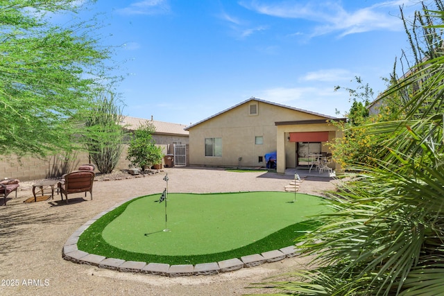 110 E Saddle Way, San Tan Valley, AZ 85143 - back of house featuring a putting area, stucco siding, a patio area, and a fenced backyard