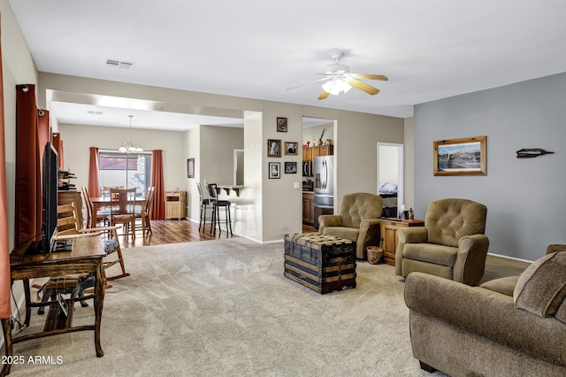 110 E Saddle Way, San Tan Valley, AZ 85143 - living area featuring a ceiling fan, carpet flooring, and a chandelier