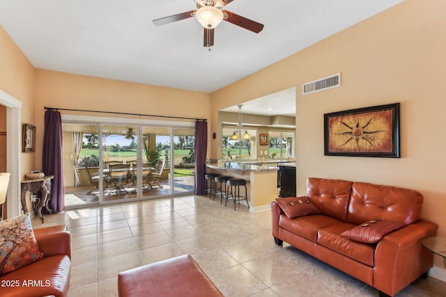 living room with ceiling fan and light tile patterned flooring