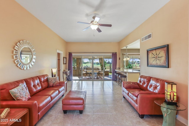 living room featuring ceiling fan and light tile patterned flooring