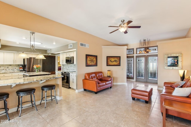 living room with ceiling fan and light tile patterned floors