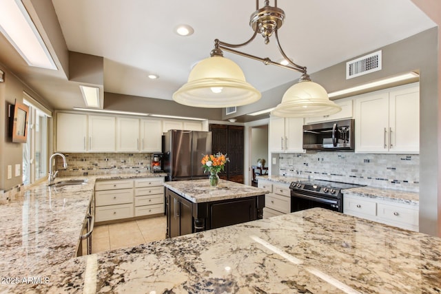 kitchen with backsplash, stainless steel appliances, sink, a kitchen island, and hanging light fixtures