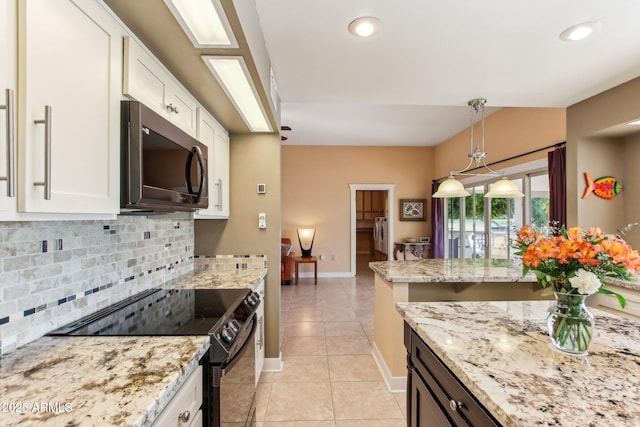 kitchen with light stone counters, black range with electric stovetop, light tile patterned floors, decorative light fixtures, and white cabinetry