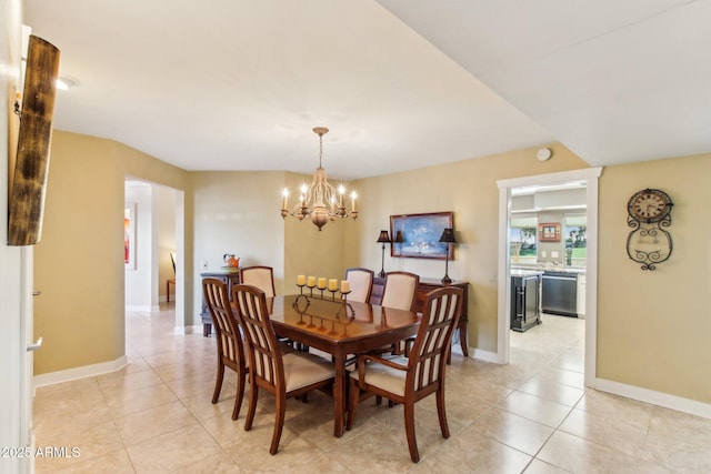 dining space with a notable chandelier and light tile patterned flooring