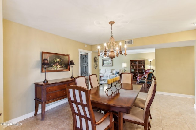 dining space featuring light tile patterned floors and a notable chandelier