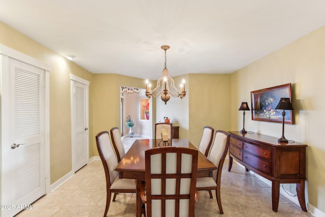 tiled dining space featuring a notable chandelier