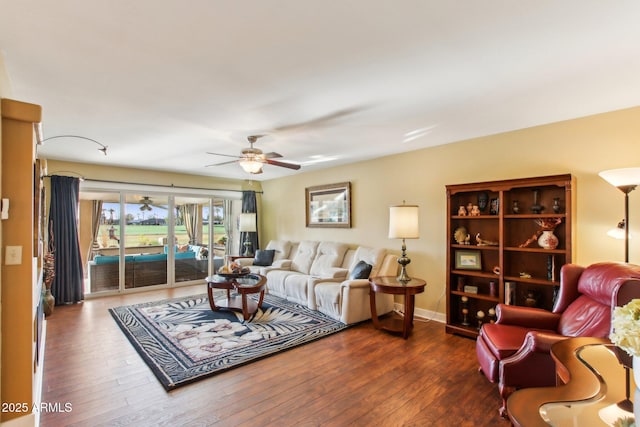 living room with ceiling fan and dark hardwood / wood-style flooring