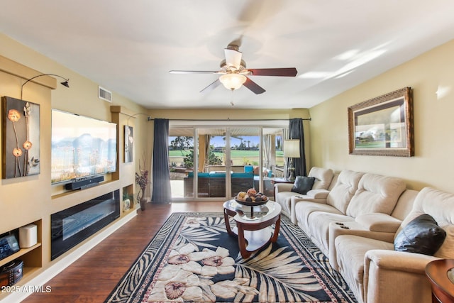 living room featuring hardwood / wood-style flooring and ceiling fan