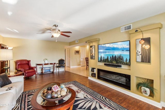 living room featuring ceiling fan and hardwood / wood-style flooring