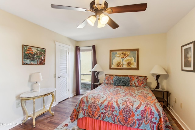 bedroom featuring ceiling fan, dark hardwood / wood-style flooring, and a closet