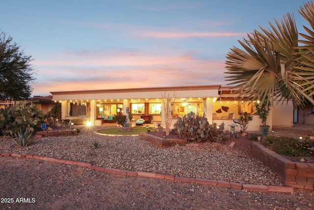 view of back house at dusk