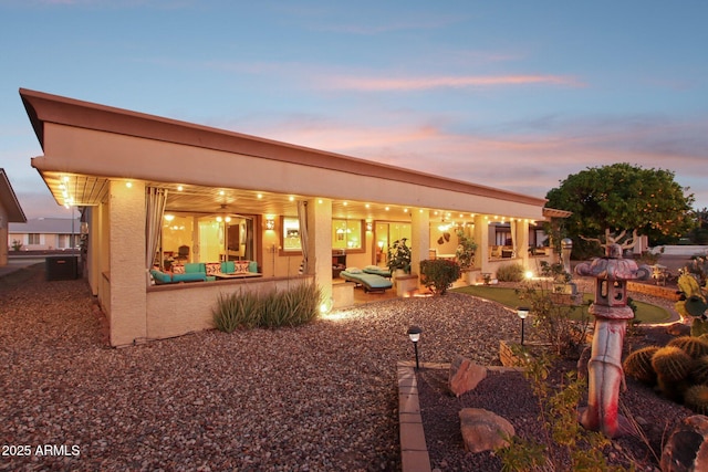 view of back house at dusk