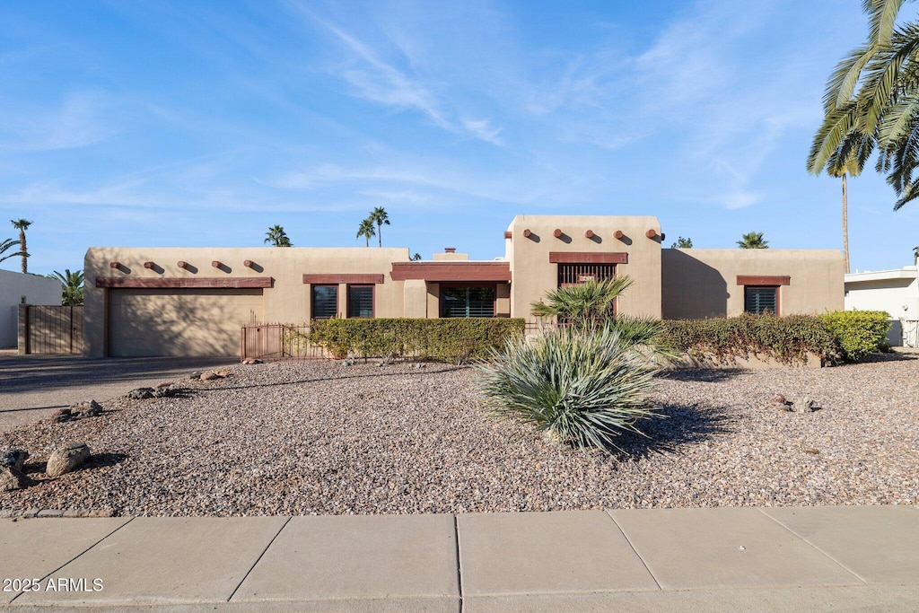 adobe home featuring a garage