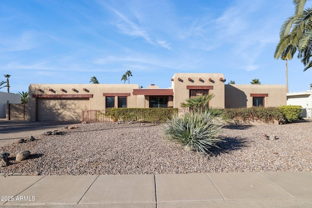 adobe home featuring a garage