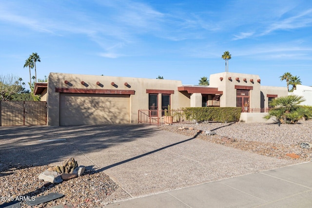 pueblo-style home featuring a garage